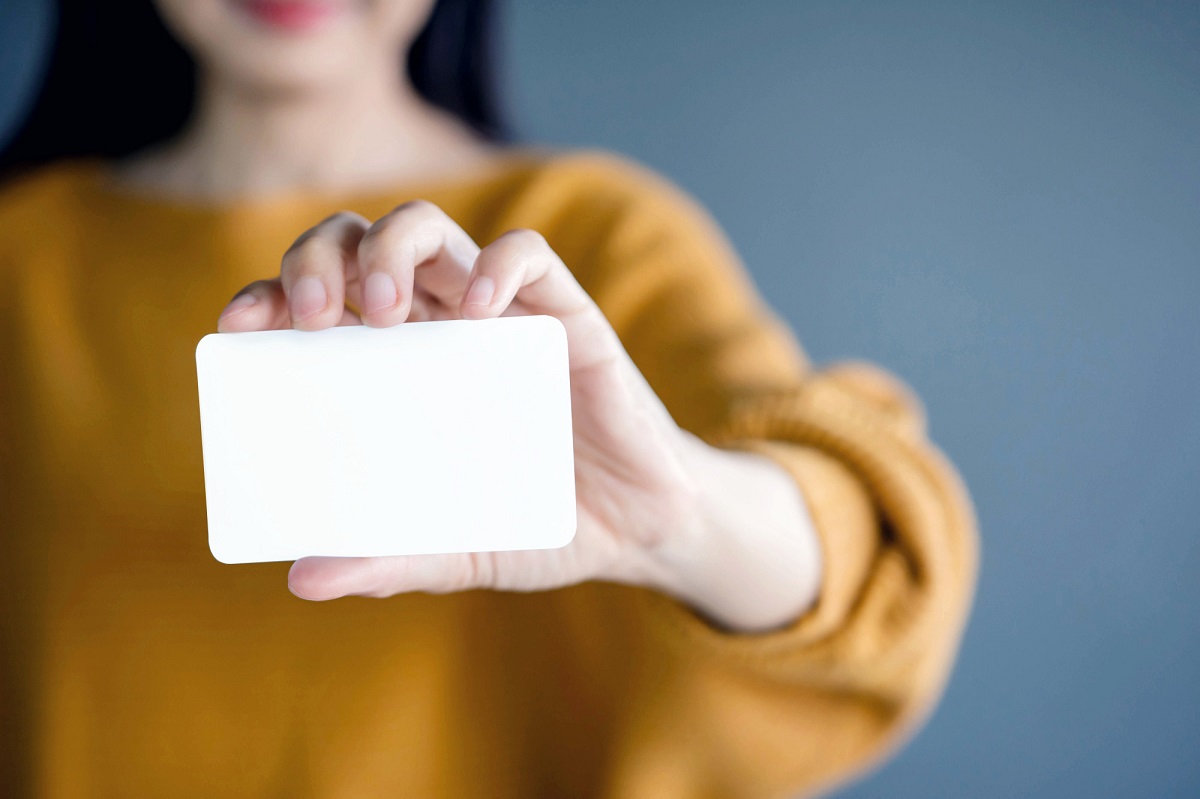 Woman holding blank business card for mock up